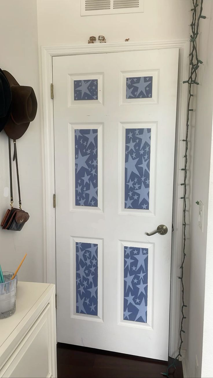 a white door with blue flowers painted on it