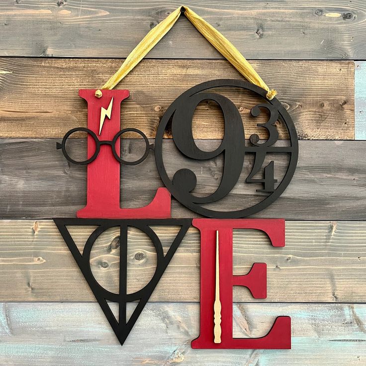 a metal sign that says love with harry potter glasses and lightning bolt hanging from it