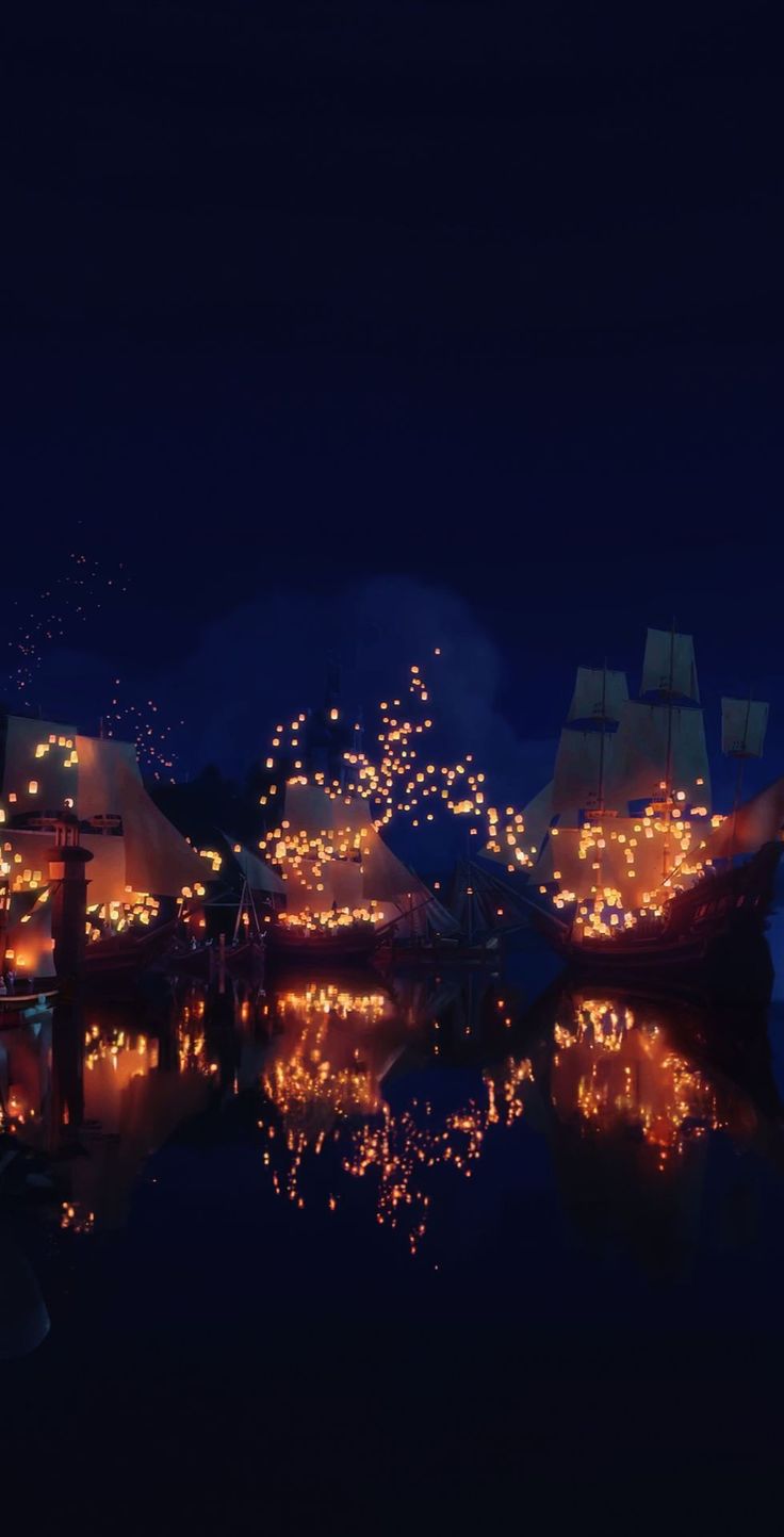 fireworks are lit up in the night sky above boats on water with mountains in the background