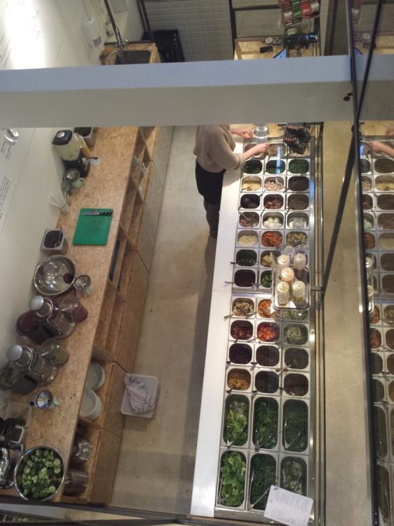 an overhead view of a food stand with several trays of food on the counter