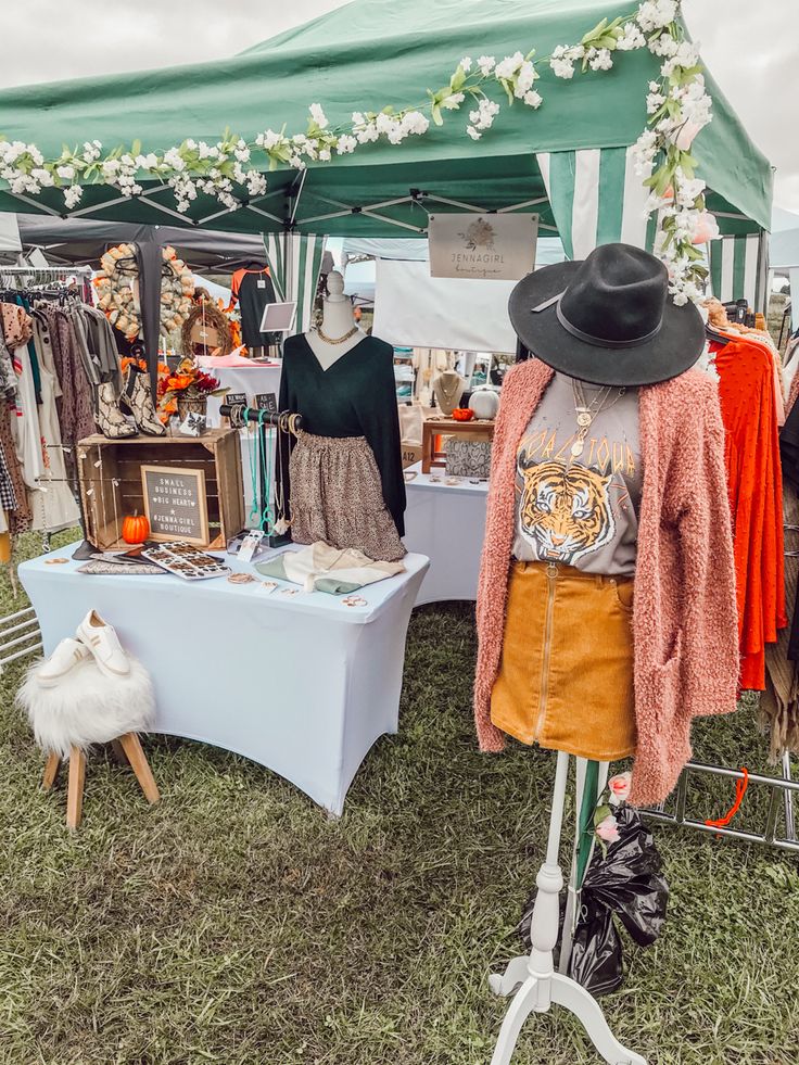 a tent with clothes and hats on display