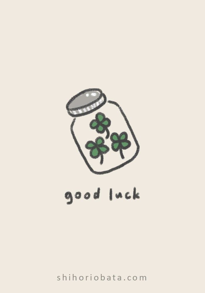 a jar filled with clovers and the words good luck