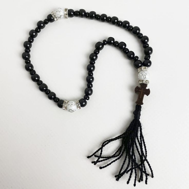 "Orthodox rosary beads are made of natural stones \"Gagat\" - which has been used since ancient times as a protective and healing stone. It is also called \"Black Jasper\" or \"Black Amber\". Splitting beads from the wood species \"Boxwood\" - which is one of the hardest wood species. Orthodox black rosary will be an amulet and protector of its owner, used for counting the prayers read or other ritual actions, preserving attention and concentration, the task of rhythm, massage nerve endings located on the fingertips, associated with the nervous system of man.  ★ Length of the rosary: 8.66 in (22 cm) ★ Bead diameter: 0.23~0.11 in (6~3 mm) ★ Number of beads: 30+5 pcs (30 gagat beads, 5 boxwood beads) ★ Dimensions of the cross: 0.69 in (17 mm) ★ All Items are made to order for each customer. Orthodox Rosary, Black Rosary, Orthodox Prayers, Black Jasper, Beaded Rosary, Rosary Beads, Spiritual Gifts, Religious Jewelry, Prayer Beads