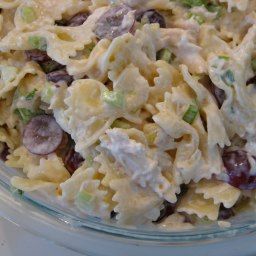 a bowl filled with pasta salad on top of a table