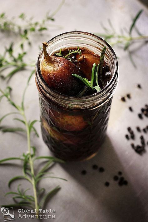 a jar filled with food sitting on top of a table next to some herbs and seeds