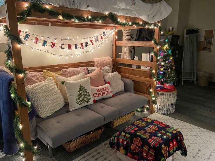 a couch with christmas lights on it in front of a bunk bed and other decorations