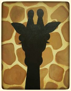 the silhouette of a giraffe is shown against a stone wall