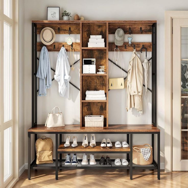 a wooden shelf filled with shoes and bags next to a wall mounted coat rack in a room