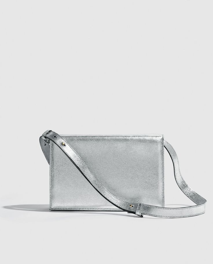 Silver metallic party bag with structured design, light and versatile. Vintage inspired.      

Made in bovine leather with metallic finish. 
Flap with magnetic clip closure.     
Adjustable and detachable long leather handle.
Open inside pocket. 
Designed and manufactured entirely in Spain using sustainable processes and small productions.
W17 cm x L25cm x D6 cm. Gold Handbag, Metallic Party, Structured Design, Handbag For Women, Gold Handbags, Design Light, Party Bag, Party Bags, New Instagram