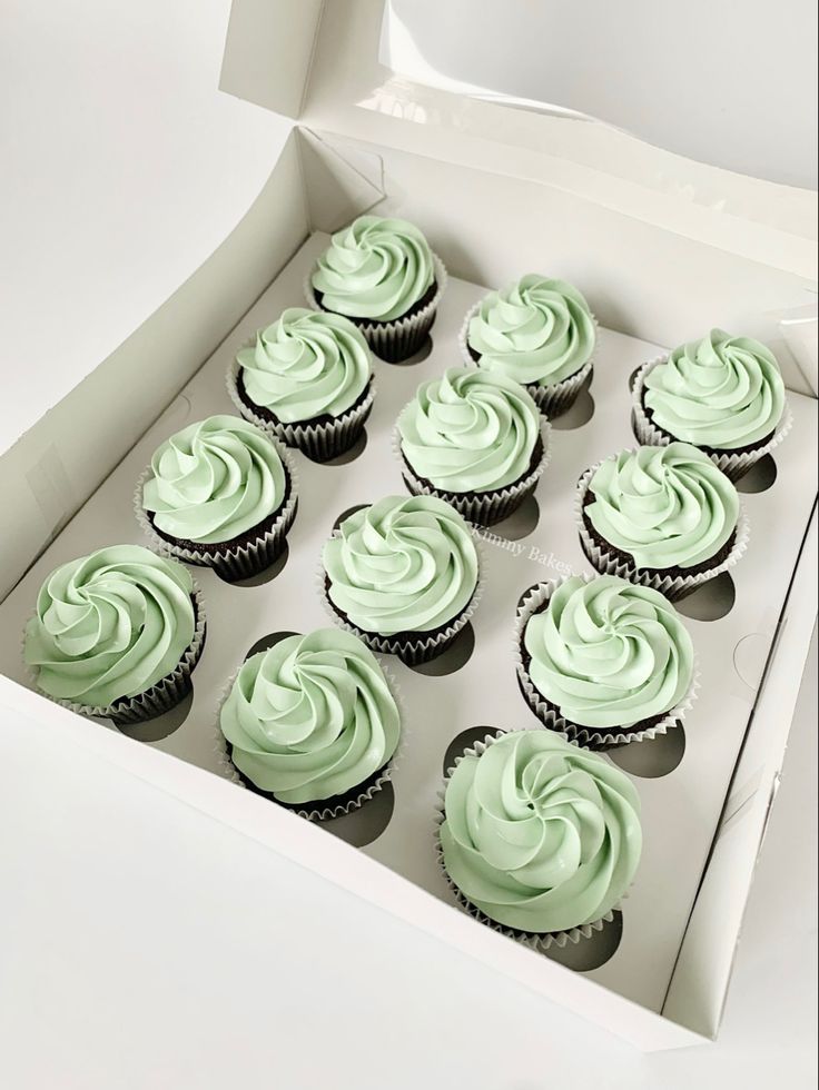 cupcakes with green frosting in a white box