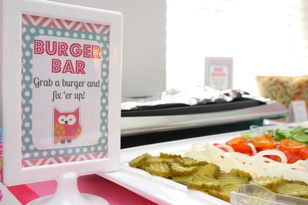 there is a plate of food with an owl sign on the table next to it that says, burger bar grab a burger and let's er up