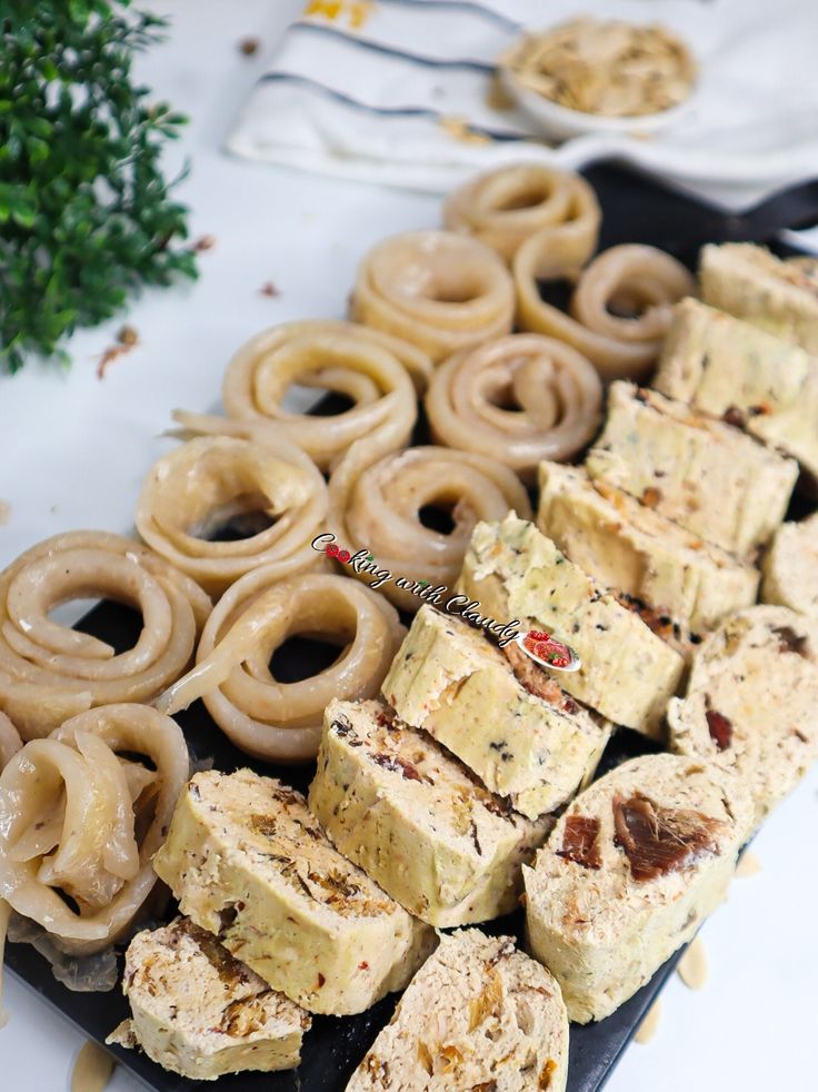 there are many different types of doughnuts on the table with other dessert items