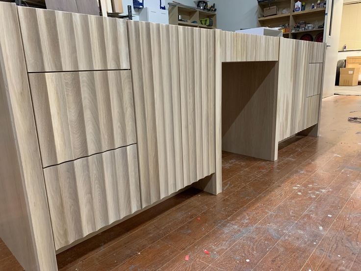 an unfinished kitchen counter in the process of being built with wood veneers and plywood