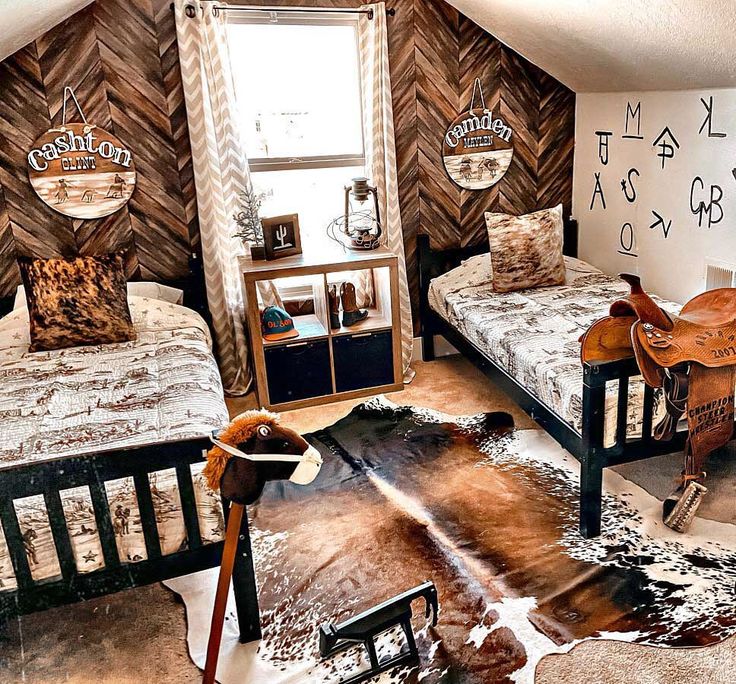 two beds in a room with cow hide rugs on the floor and other furniture