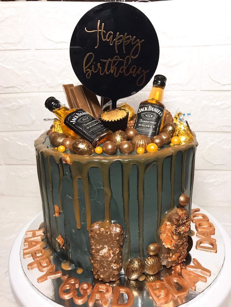 a birthday cake decorated with chocolate and gold decorations