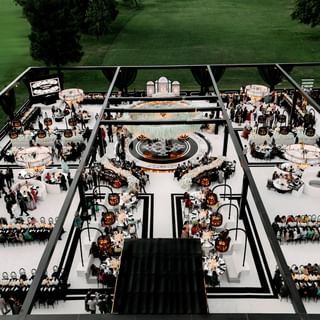 an aerial view of a dining room set up for a formal function in the middle of a field