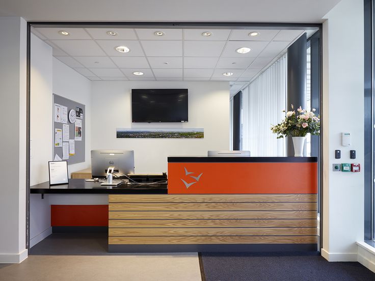 the front desk of an office with flowers on it