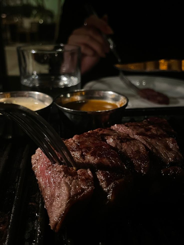 the steak is being cooked on the grill