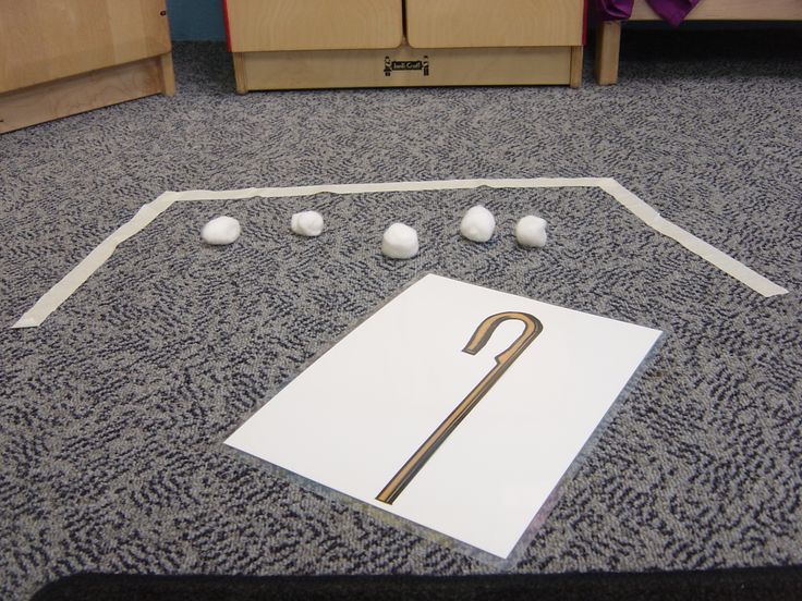 an umbrella is on the floor next to some balls and a piece of white paper