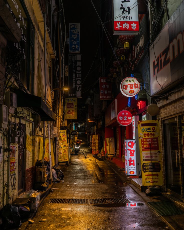 an alley way with many signs on the buildings