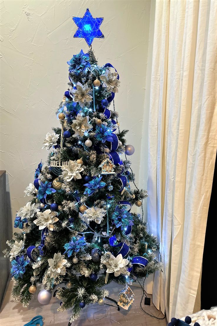 a blue and white christmas tree with ornaments