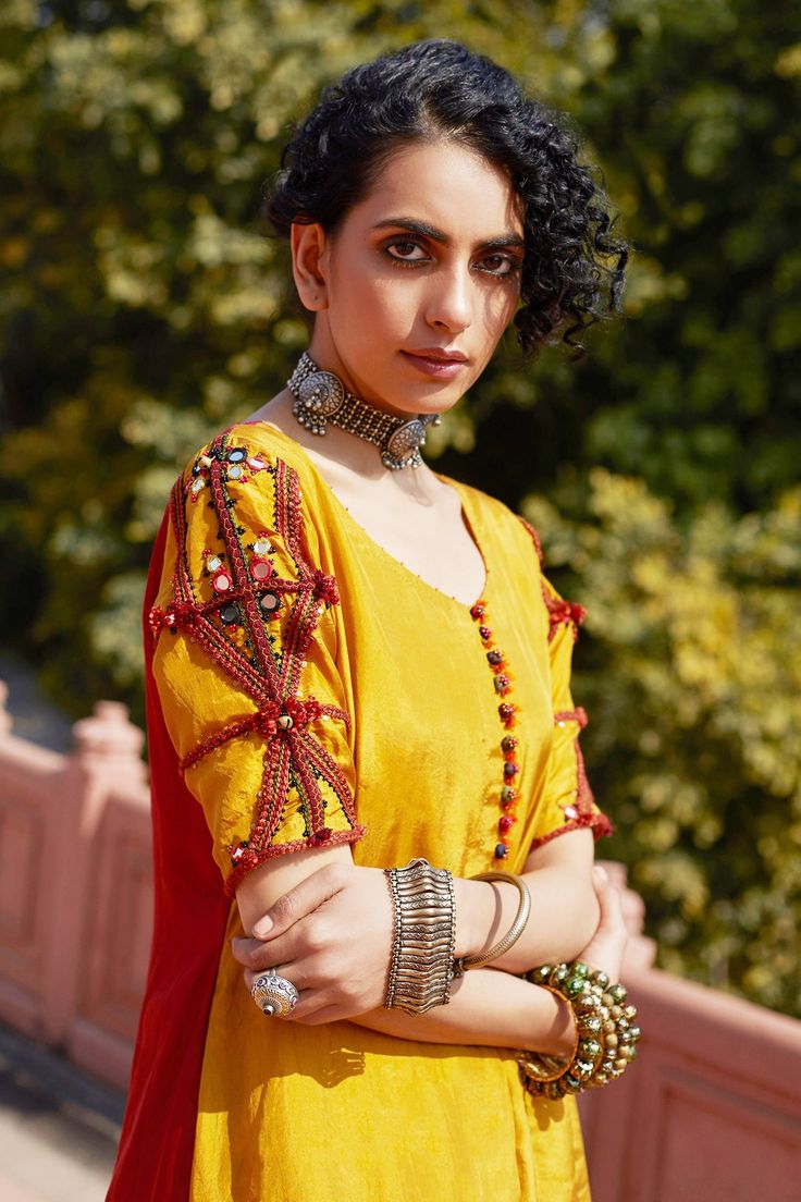 Yellow kurta with handcrafted button placket, embroidered sleeves and contrast bandhani print back panel. Paired with crochet hem tissue kota pant and linen embroidered orange dupatta.
Component: 3
Embroidered
Neckline: Round
Sleeve Length: Short
Fabric: Habutai Silk,Linen, Tissue Kota
Color: Yellow
Crochet border pant
Embroidered sleeves - Aza Fashions Orange Dupatta, Silk Kurta Set, Embroidered Orange, Bandhani Print, Yellow Kurta, Crochet Hem, Crochet Border, Yellow Crochet, Kurta Set For Women