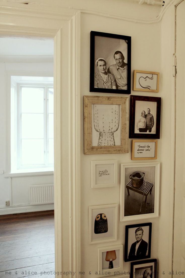 a wall filled with pictures and framed photos