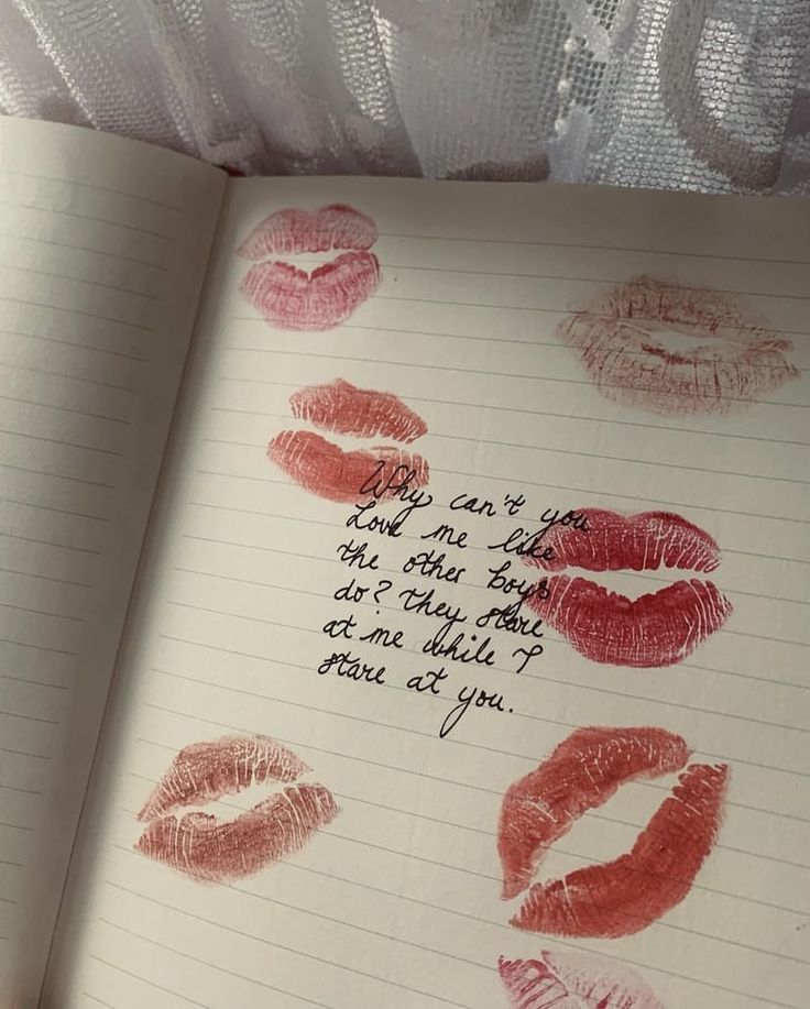 an open notebook with lipstick drawn on it