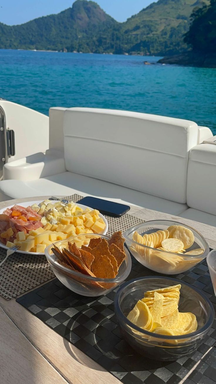 plates of food sit on the deck of a boat