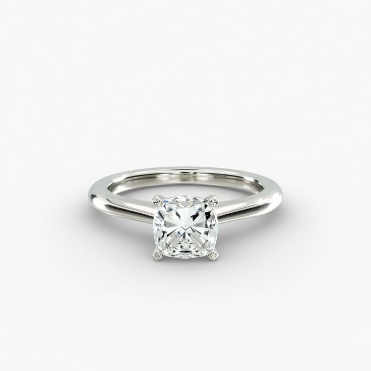 a white gold ring with a cushion cut diamond