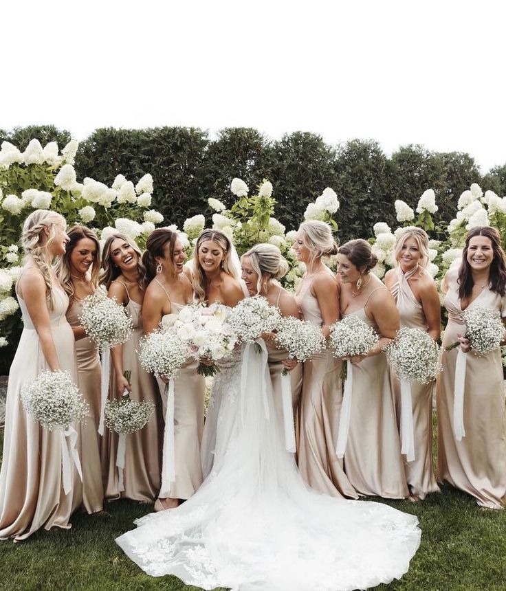 a group of women standing next to each other on top of a lush green field