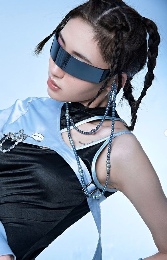 a woman in black and blue is wearing a blindfold