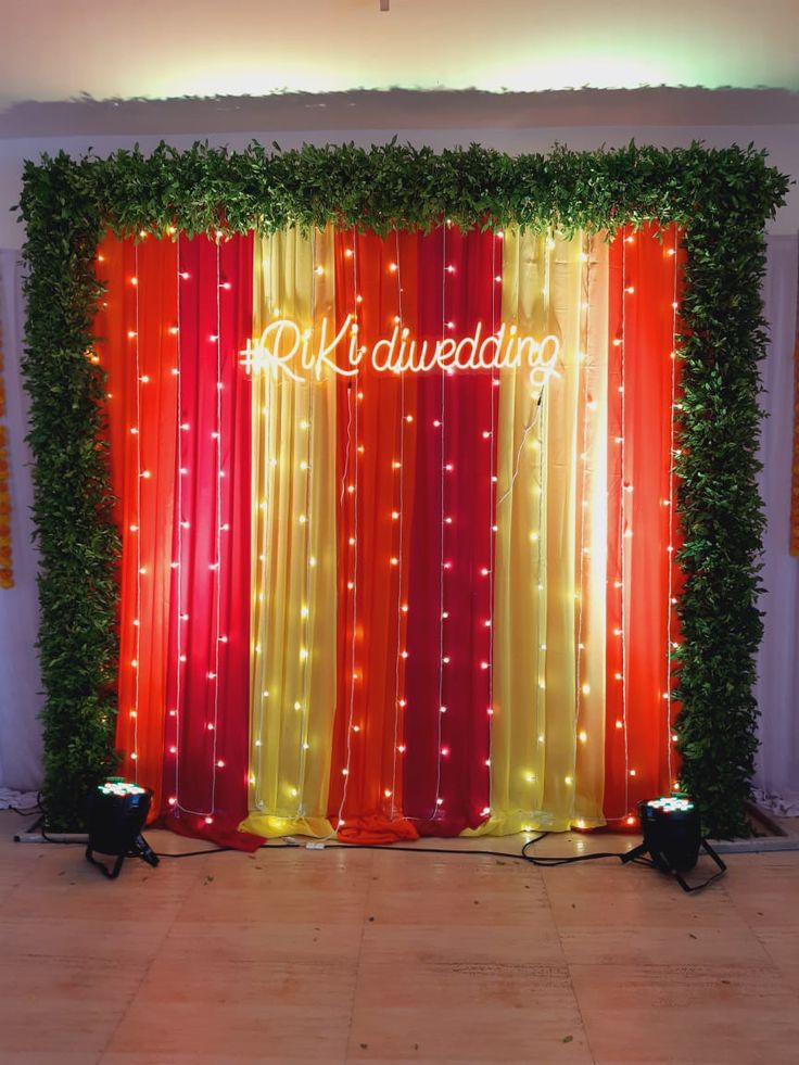 the backdrop is decorated with red, yellow and orange drapes