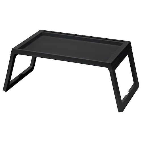 a black coffee table sitting on top of a white floor