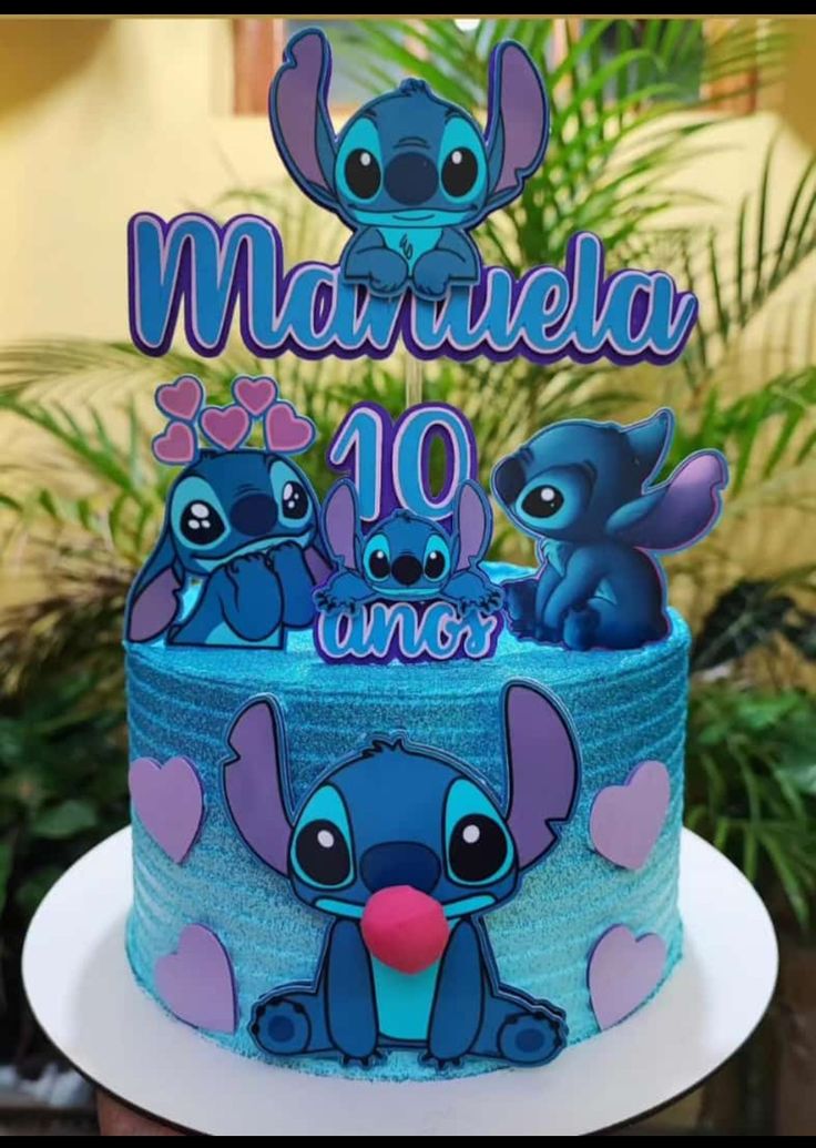 a blue cake with some little stitchers on it's top and the name marmela