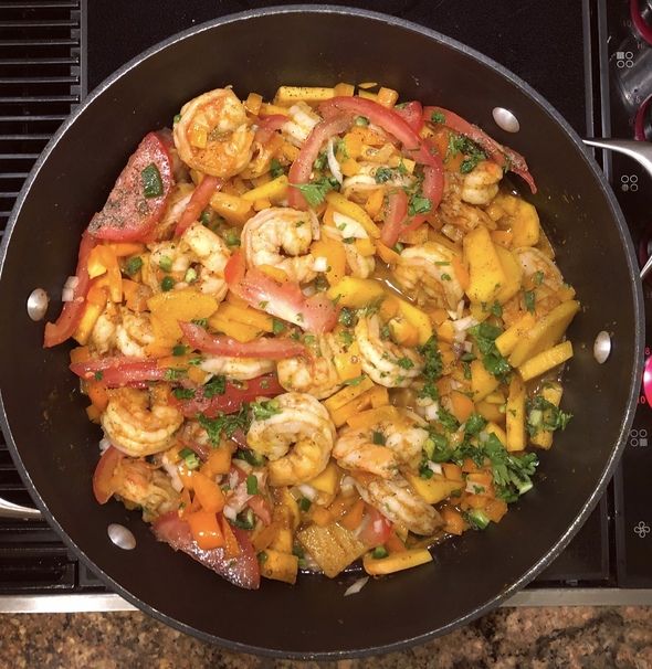 shrimp and bell peppers in a skillet on the stove