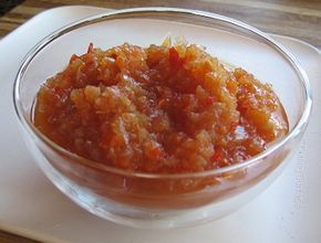 a glass bowl filled with food on top of a white plate