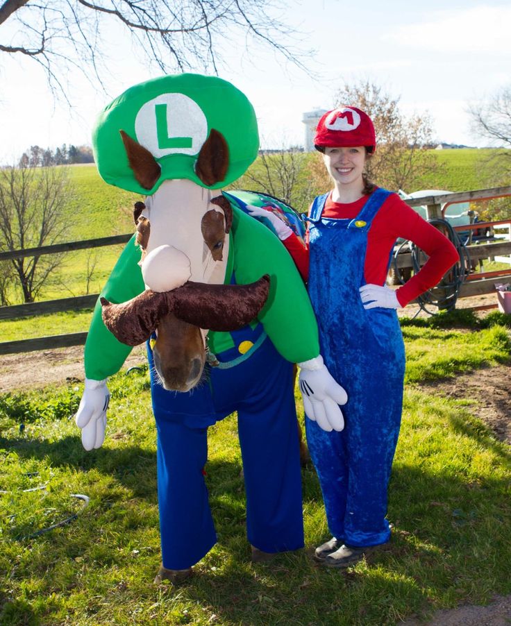 two people in mario and luigi costumes standing next to each other