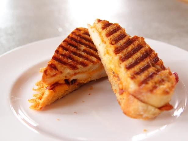 two grilled sandwiches on a white plate