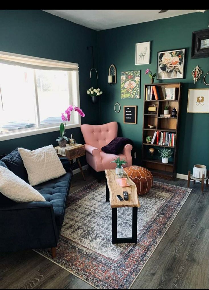 a living room filled with furniture and a rug on top of a hard wood floor