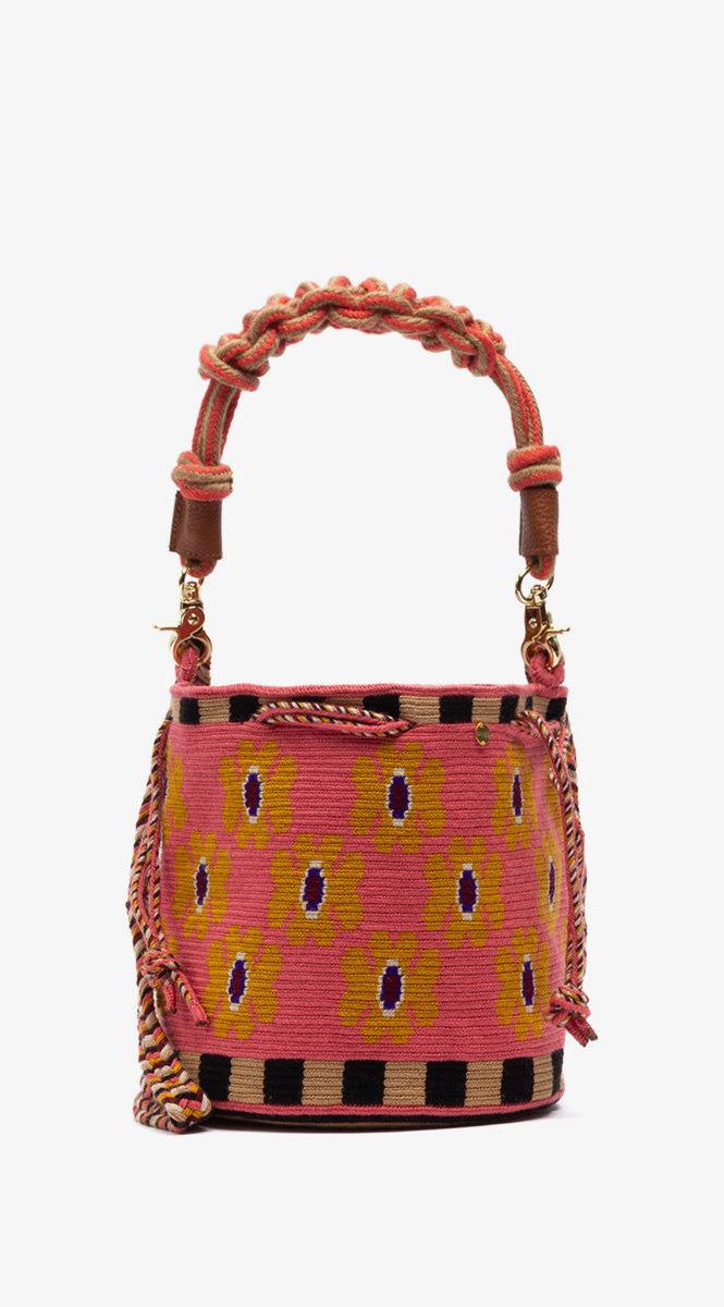 Guanabana's Mitra bag symbolizes Mitra, the Hindu god of friendship, which is defined as the bond Guanabana shares with Wayuu artisans in Colombia, bringing this bag to life. This variant of the classic Wayuu bag features a practical cord closure that can be knotted or adjusted to suit your needs. The vibrant colors and intricate patterns make it truly special. Mitra also carries our signature bronze tag with GUANABANA's mantra: BE POSITIVE. Hand-knitted on Crochet Material: 100% acrylic Approximate dimensions: Height: 7.87" (20 cm) Diameter: 7.87"(20 cm) Handle: 45.2"(115cm) Each bag is handmade, which makes each piece unique. There can be a small design variance. Machine washable in cold water. Traditional Bucket Bag With Removable Pouch, Traditional Bucket Bag With Leather Handles For Daily Use, Traditional Bucket Bag With Leather Handles, Bohemian Pouch Bucket Bag With Leather Handles, Bohemian Crochet Bucket Bag With Leather Handles, Bohemian Handwoven Top Handle Bag, Bohemian Top Handle Bucket Bag, Traditional Bucket Bag With Adjustable Strap, Traditional Bucket Shoulder Bag With Adjustable Strap