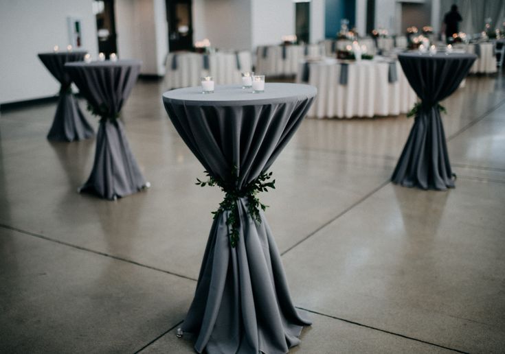 the tables are set up with white linens and silver tablecloths for an elegant wedding reception