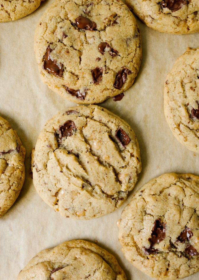 chocolate chip cookies sitting on top of parchment paper