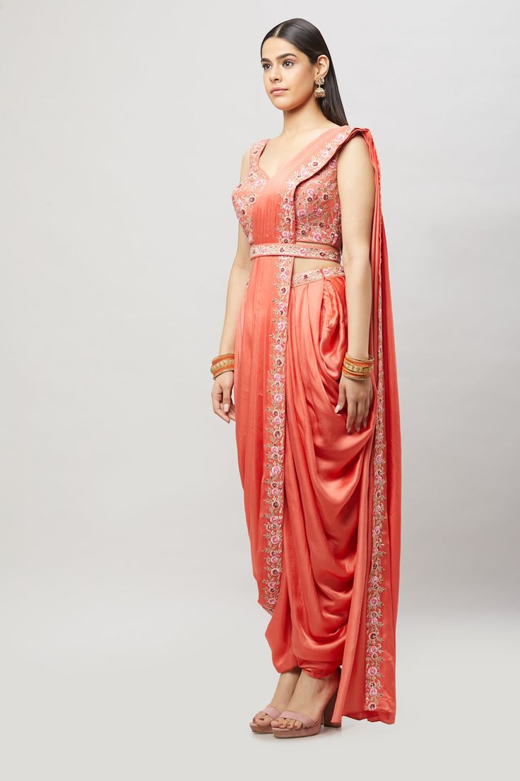 Modern, fun and chic! This readymade coral dhoti saree with multi-resham embroidery is perfect for any bridal event! Fabric: Satin silk Ready to Ship Occasion: Sangeet, Mehendi Events WASH CARE INSTRUCTIONS - Please Dry clean only when it is applicable. Slight color variation is possible due to digital photography. Jewelry not included Embroidered Draped Lehenga For Wedding, Embroidered Draped Traditional Wear For Diwali, Embroidered Draped Traditional Wear For Wedding, Embroidered Draped Traditional Wedding Wear, Traditional Draped Wear With Resham Embroidery For Eid, Embroidered Draped Dupatta For Diwali, Designer Wear Draped Sharara With Resham Embroidery, Traditional Chanderi Draped Dupatta, Traditional Pink Draped Lehenga