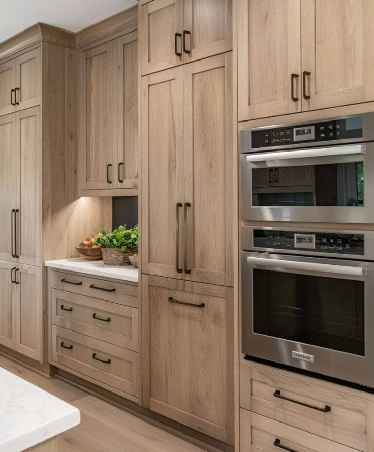 a large kitchen with wooden cabinets and stainless steel appliance, including an oven