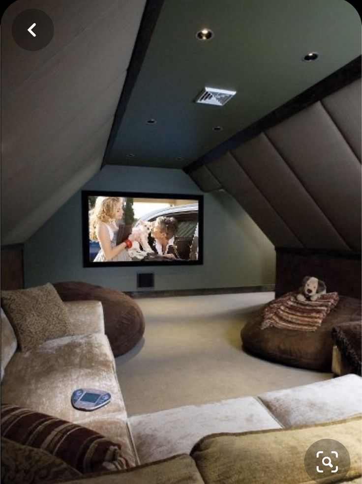 a home theater in the corner of a room with two couches and a television