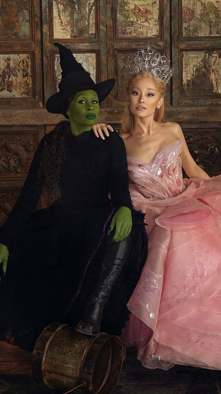 two people dressed in costumes sitting next to each other