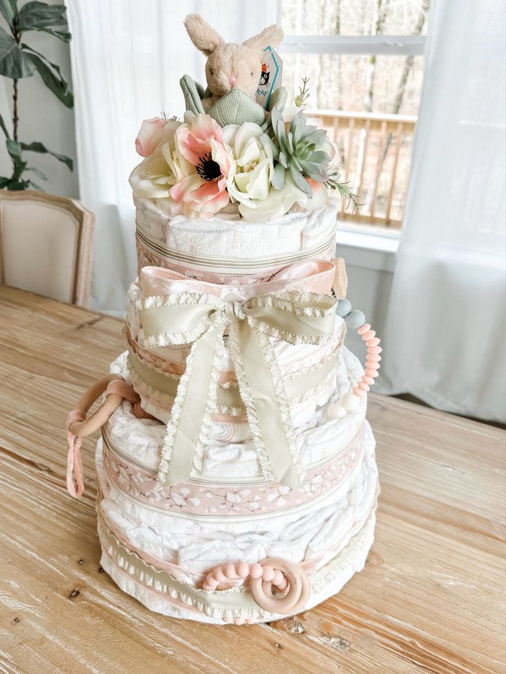 Spring / Easter themed baby girl diaper cake Diaper Tower Ideas, Creative Diaper Gifts, Diaper Cake Baby Girl, Diaper Cake Ideas Girl, Cowgirl Diaper Cake, Floral Diaper Cake, Baby Girl Diaper Cake Ideas, Boho Diaper Cake Girl, Baby In Bloom Diaper Cake