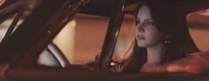 a woman sitting in the passenger seat of a car