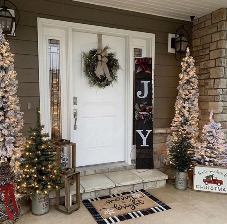 front porch decorated with christmas trees and wreaths